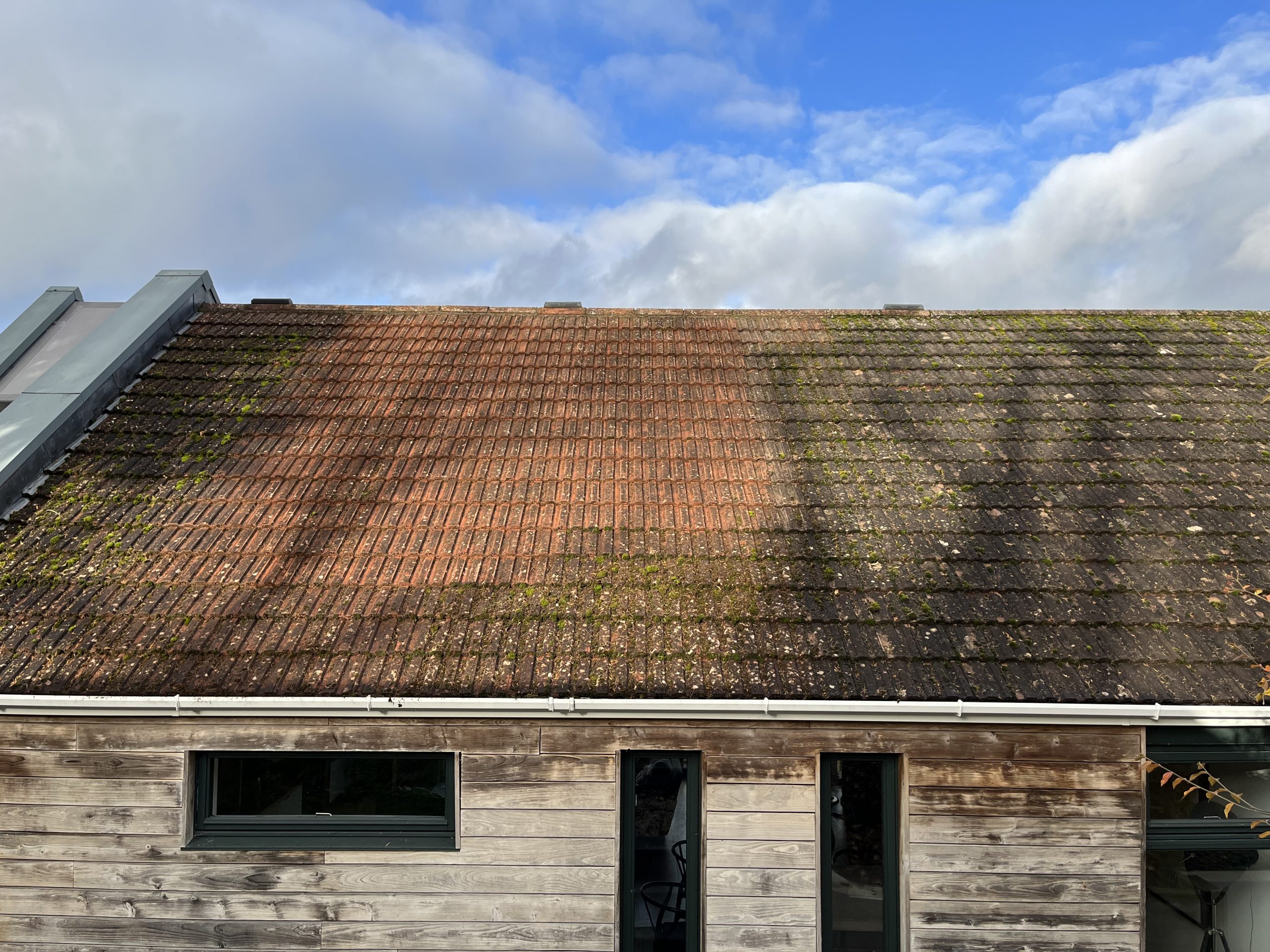 This is a roof we cleaned in Bath, it is a tile roof that is in the process of getting cleaned by scraping the moss off and then applying a biocide.